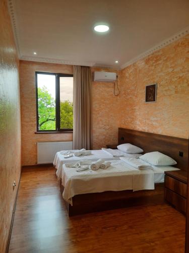Llit o llits en una habitació de Inaisi Hotel