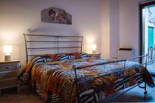 a bedroom with a bed and a picture on the wall at Casa R&G Lorica in Lorica