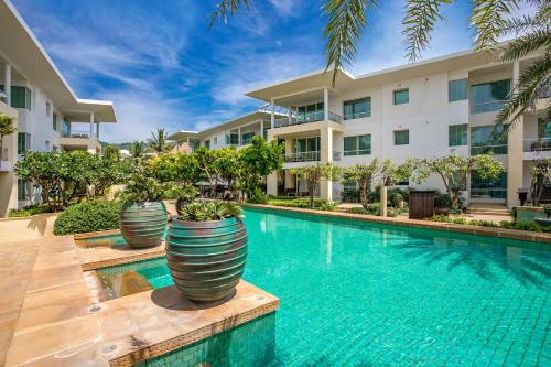 an image of a swimming pool in front of a building at Happy Apartment on Karon Beach in Karon Beach