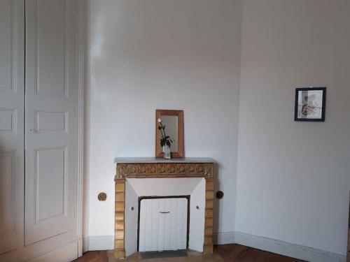 a fireplace in the corner of a room at Maison de ville proche beauval avec parking in Selles-sur-Cher