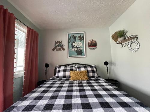 a bedroom with a black and white checkered bed at Millz Manor in Fall River Mills