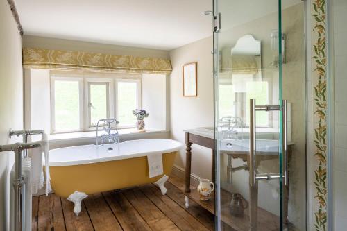 a bathroom with a tub and a glass shower at Enderley in Salisbury