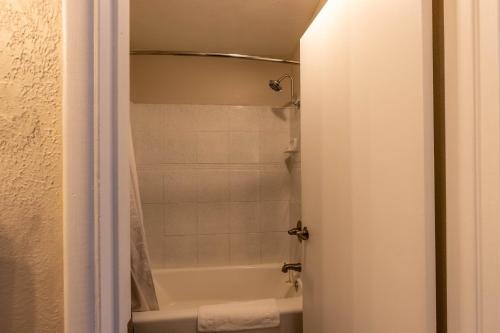 a bathroom with a shower and a bath tub at Cedars Resort in Sedona