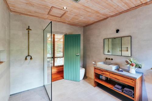 a bathroom with a shower and a toilet and a sink at Burnside Organic Farm in Margaret River Town