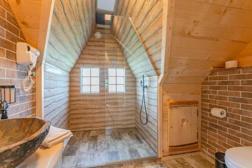 a large bathroom with a sink and a shower at Cabane de Poveste in Bran