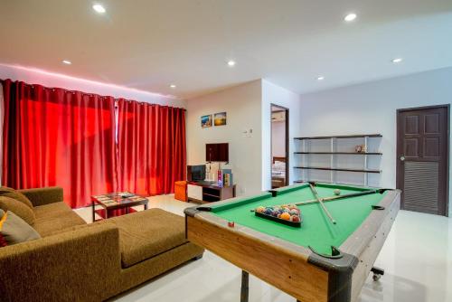 a living room with a pool table at Sweet Party Hua-Hin Private Poolvilla From beach 3km in Hua Hin