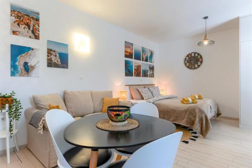 a living room with a table and a couch at Studio Mare in Zadar