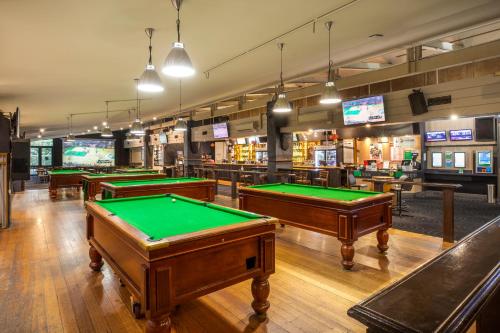 a row of pool tables in a gaming room at Burvale Hotel in Nunawading