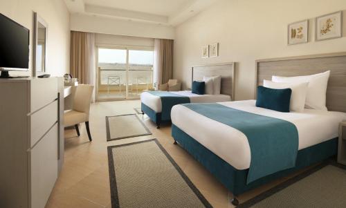 Ein Bett oder Betten in einem Zimmer der Unterkunft JAZ Soma Beach