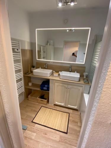 La salle de bains est pourvue de 2 lavabos et d'un grand miroir. dans l'établissement Saint Tropez Spacieux Appartement La Florida, à Saint-Tropez