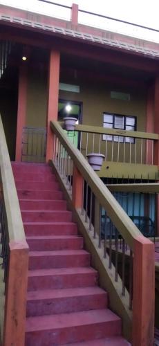 a set of stairs leading to a building at view point homestay in Mawlynnong