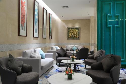 a waiting room with couches and chairs and tables at Asia International Hotel Guangdong in Guangzhou