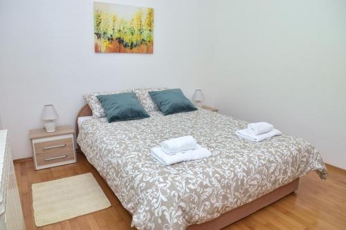 a bedroom with a bed with two towels on it at Apartman Buongiorno in Jajce