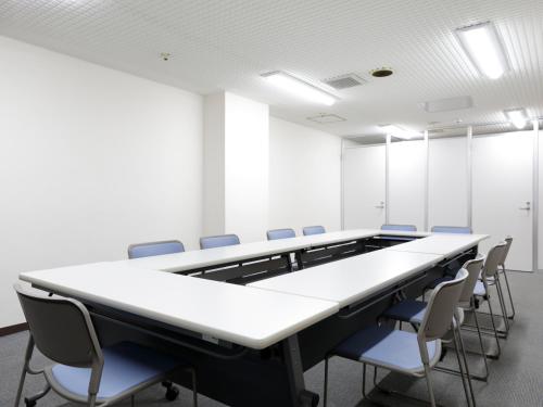 a conference room with a long table and chairs at Tokyo Inn in Tokyo
