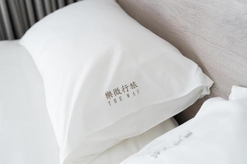 a close up of a pillow on a bed at The Way Inn in Taichung