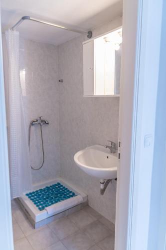 a bathroom with a shower and a sink and a shower at Megaro in Elounda