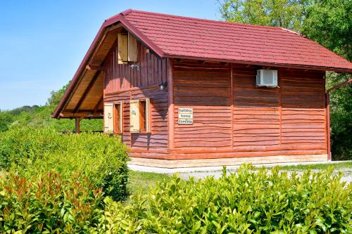 a small wooden cabin with a red roof at Holiday Home Fančita in Tuheljske Toplice