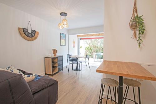un salon avec un canapé et une table dans l'établissement Motte du Couchant, 6 personnes, 4 min de la plage, Parking, Climatisation, à La Grande Motte