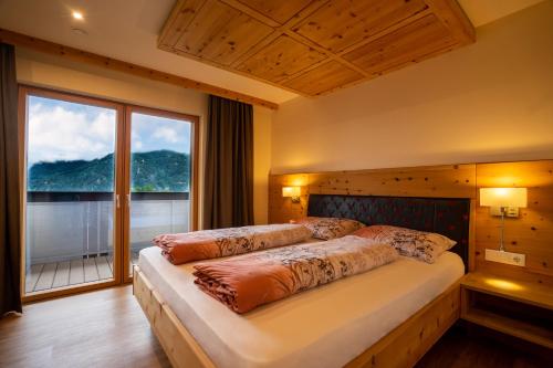 a bedroom with a large bed with a large window at Luxapart in Ladis