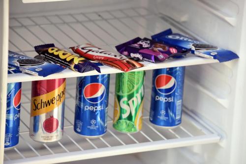 a refrigerator filled with lots of snacks and soda at Giza Pyramids View Inn in Cairo