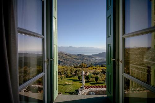 an open window with a view of a mountain view at Gerofotis Traditional Guesthouse est 1892 - Close to Aigio, Akoli, Selianitika in Lákka