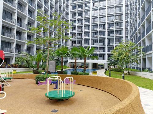 a playground in front of a large apartment building at Home away from Home in Manila