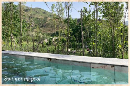a swimming pool with a view of a mountain at Spring Family Guest House in Tersak