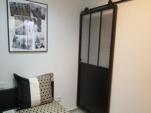 a black door in a room with a couch at La passerelle in Pouzols