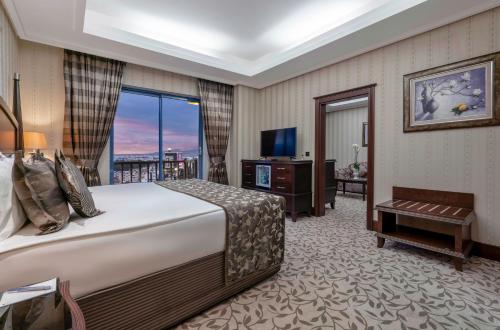 a hotel room with a bed and a large window at Merit Lefkosa Hotel & Casino in Lefkosa Turk