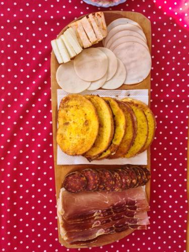 a tray of different types of bread and pastries at OPG DIJANA in Kopačevo