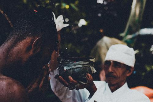 a man taking a picture of a man holding a trophy at Desa Eko in Munduk