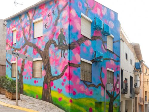 a painting of a tree on the side of a building at Casa de l'Arbre in Aitona