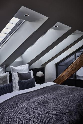 a bedroom with a large bed and a window at Hotel Liberty Offenburg in Offenburg