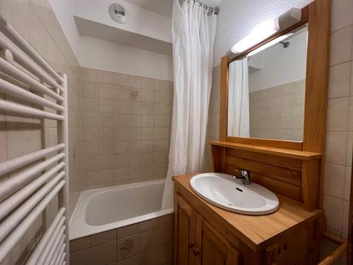 a bathroom with a sink and a bath tub at LA RESIDENCE 2-234 - Proche centre du village avec garage in La Clusaz