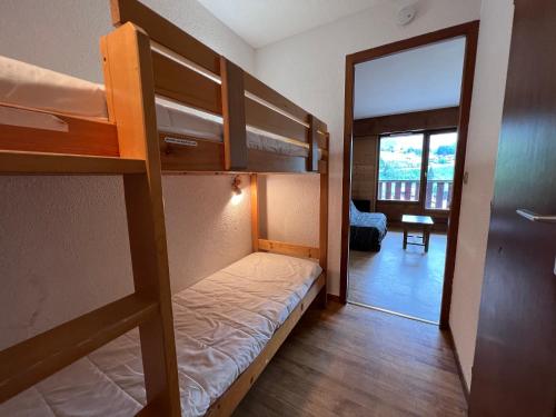 a small room with bunk beds and a hallway at LA RESIDENCE 2-234 - Proche centre du village avec garage in La Clusaz