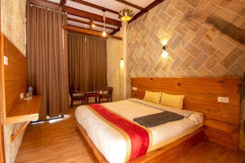 a bedroom with a large bed in a room at Peaceful Cottage & Cafe Du Mont in Nagarkot