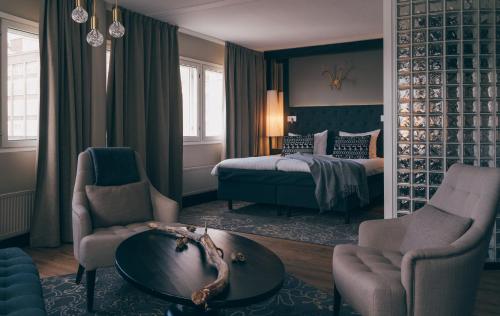 a bedroom with a bed and a table and chairs at Lapland Hotels Tampere in Tampere