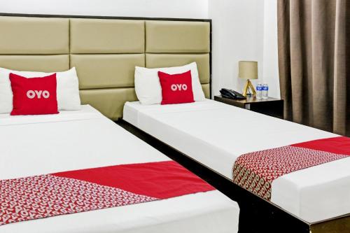 Gulta vai gultas numurā naktsmītnē OYO 869 Jnv Dream Hotel