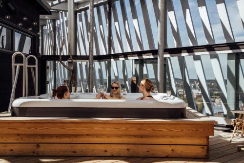 three women in a bath tub on a ship at Lapland Hotels Arena in Tampere