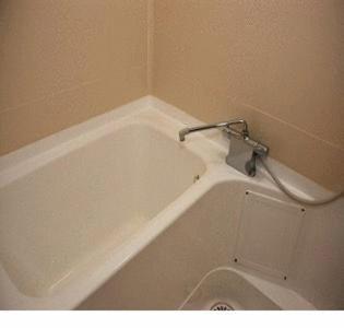 a white bath tub with a shower in a bathroom at Gion Fukuzumi in Kyoto