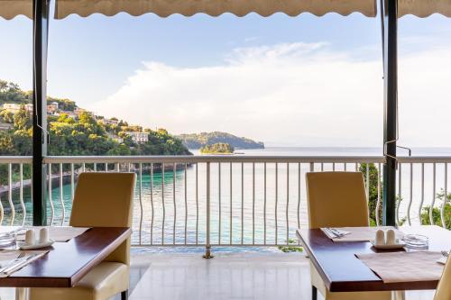 a restaurant with a view of the ocean at Oasis Hotel in Perama