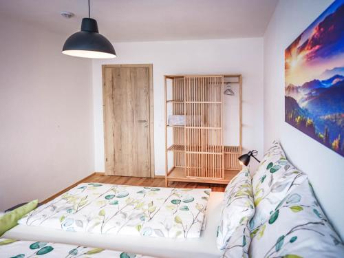 a bedroom with a bed and a book shelf at Apartments Frauensee in Reutte