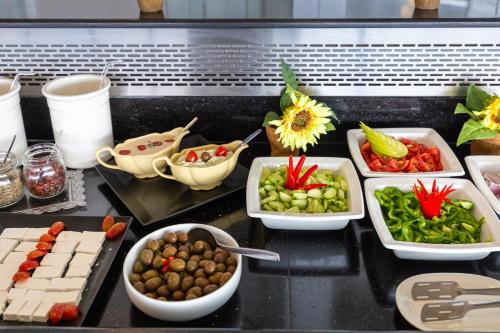 a buffet with different types of food on a table at Oasis Hotel in Perama