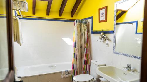 a bathroom with a tub and a sink and a toilet at Fuente De Las Anjanas in Estrada