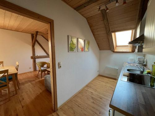 a kitchen with a sink and a table in a room at Ölmühle Eberstedt in Eberstedt