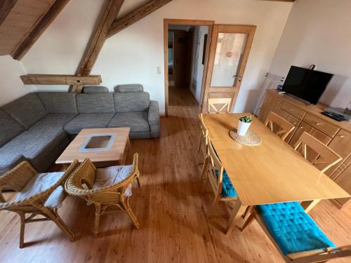 a living room with a couch and a table at Ölmühle Eberstedt in Eberstedt