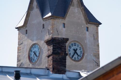 a clock tower with two clocks on it at Hotel Mohelnice in Mohelnice