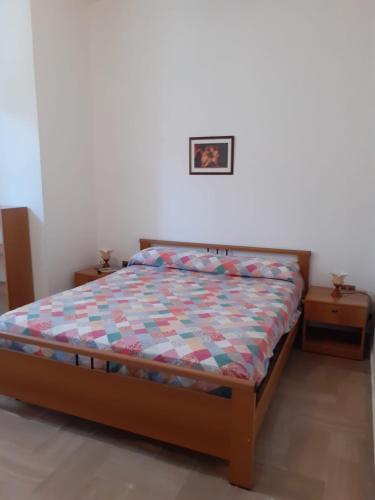 a bedroom with a bed and two night stands at La Casa di Zorbas in Cariati