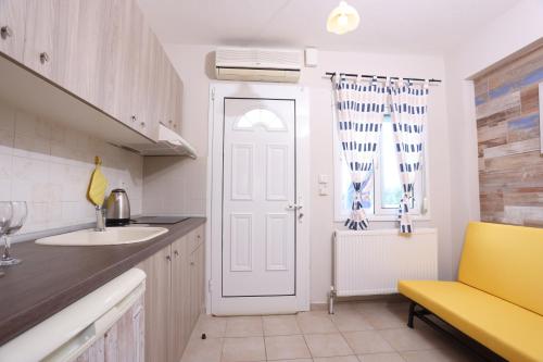 a kitchen with a sink and a white door at Para Thin Alos in Polykhrono