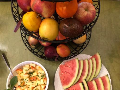 a table with a basket of fruit and a bowl of food at Gästehaus Susanne Pfaffmann in Landau in der Pfalz